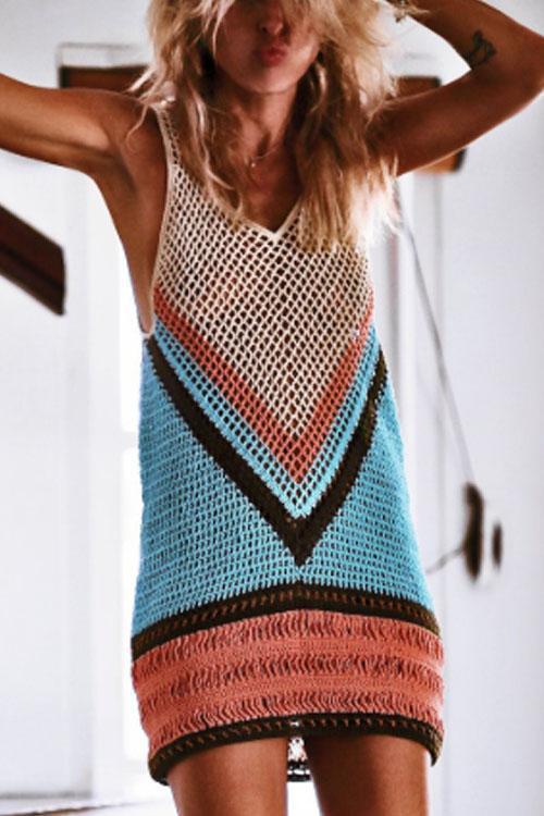 White boho beach dress with openwork crochet-style detailing worn as a swimwear cover-up