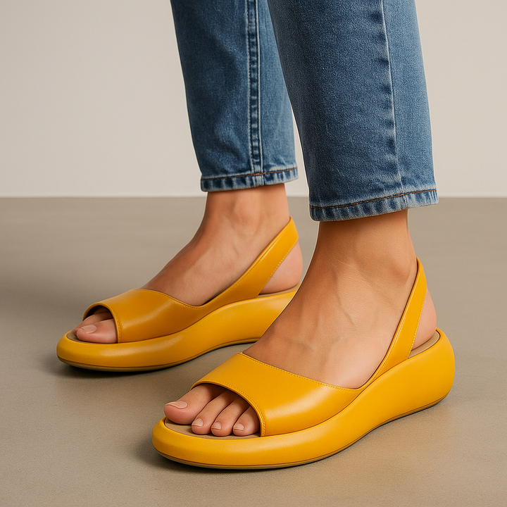 Minimal flat sandals in white, pink, blue, yellow and orange with a cushioned supportive sole