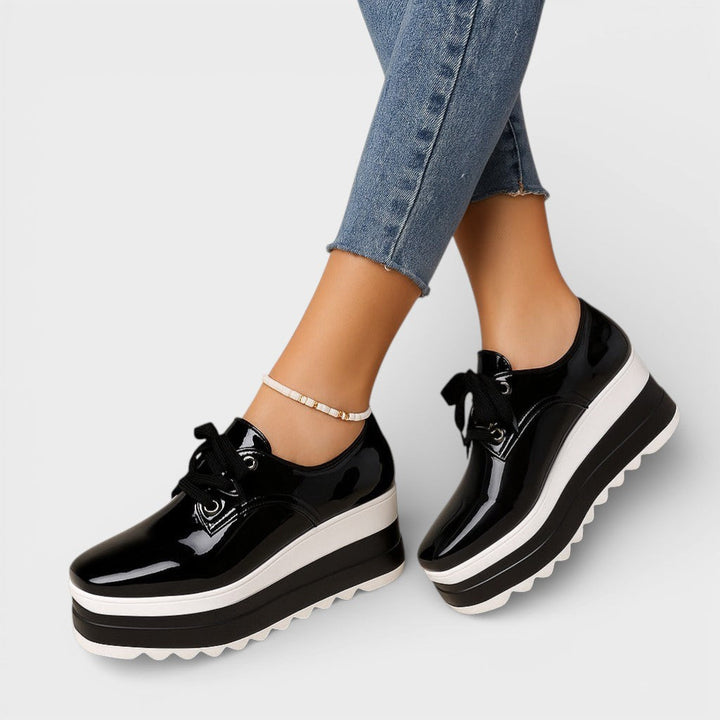 Women's platform trainers in beige with a cushioned sole and glossy contemporary finish