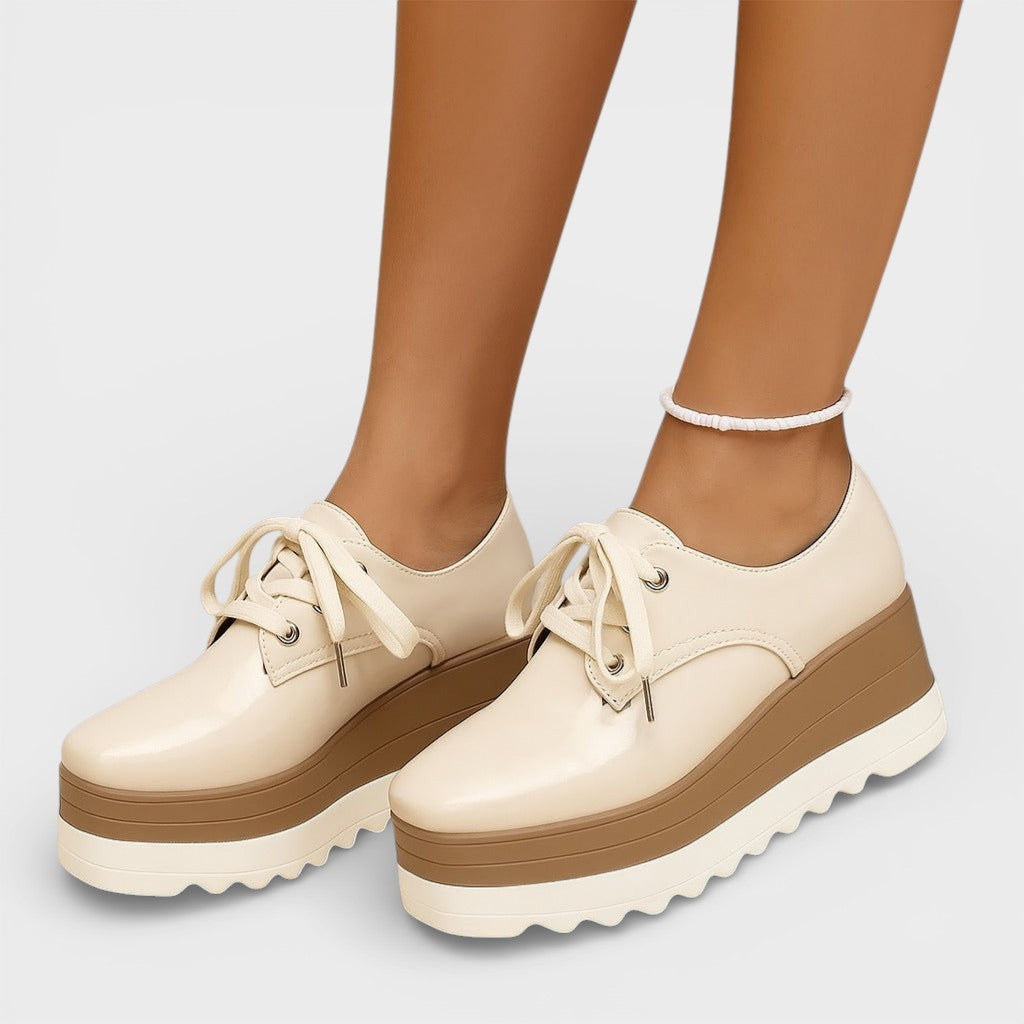 Women's platform trainers in beige with a cushioned sole and glossy contemporary finish