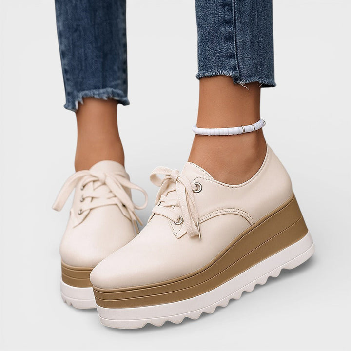 Women's platform trainers in beige with a cushioned sole and glossy contemporary finish