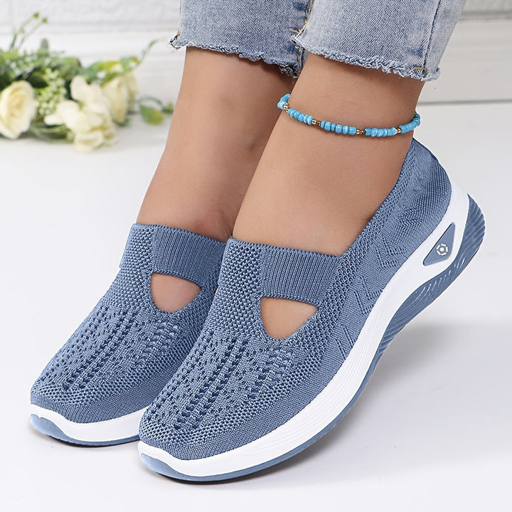 A woman stepping into easy slip-on comfort trainers with no laces.