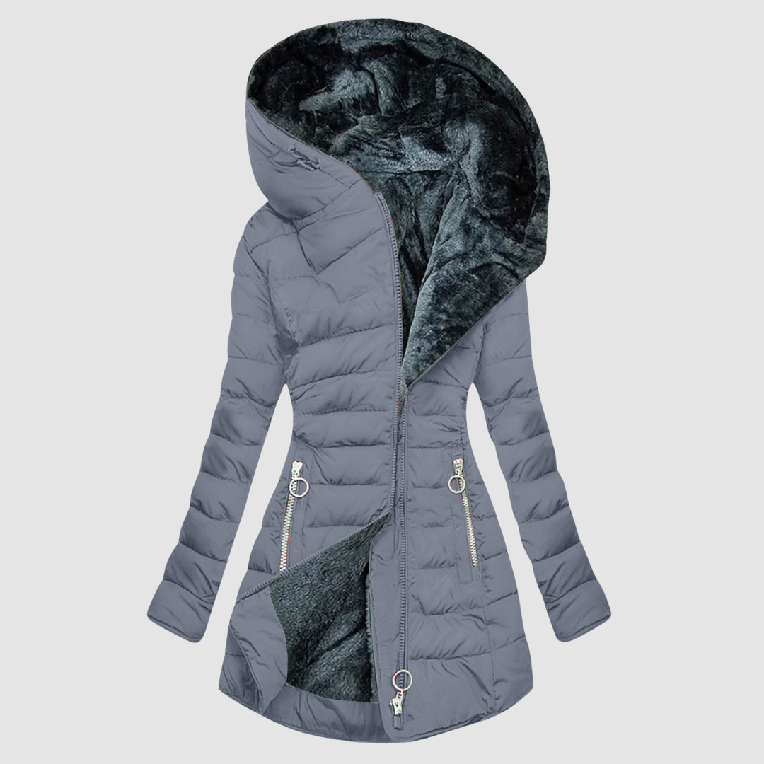 A woman wearing a cosy lined winter coat with a soft collar, looking warm and elegant.