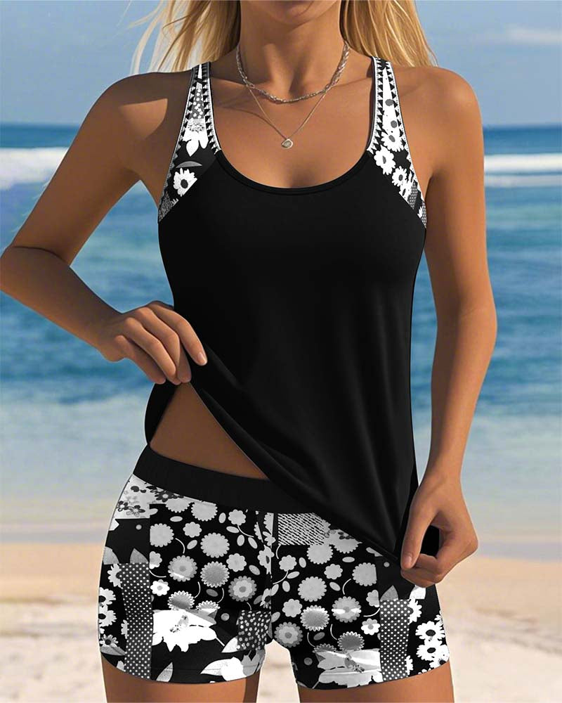 Floral tankini with shorts bottom in purple and soft tones, displayed on a light background