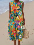 A sleeveless midi dress with a vibrant oversized floral burst print in orange, pink and complementary tones