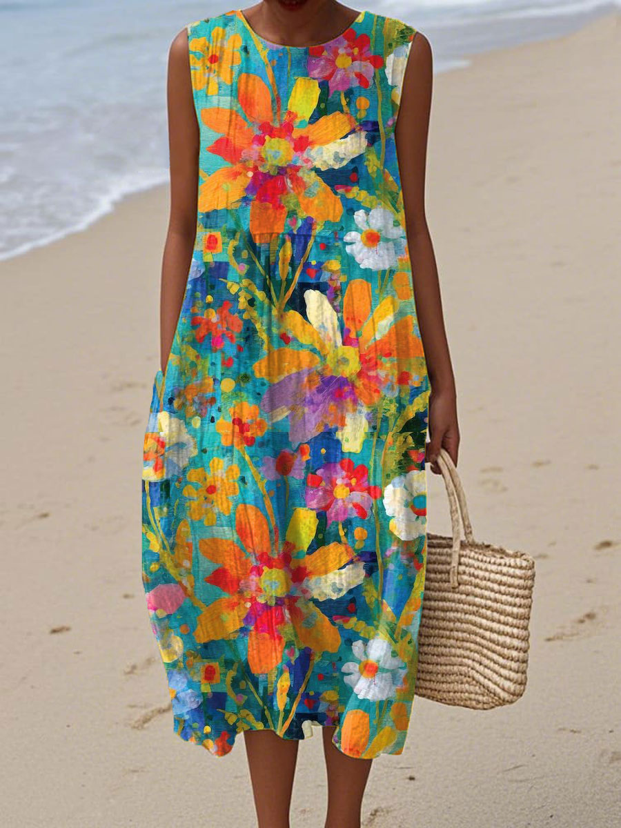 A sleeveless midi dress with a vibrant oversized floral burst print in orange, pink and complementary tones