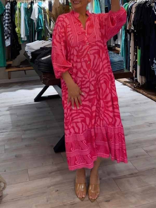 Woman wearing the Oonagh™ vivid printed maxi dress with a button front, standing confidently outdoors.