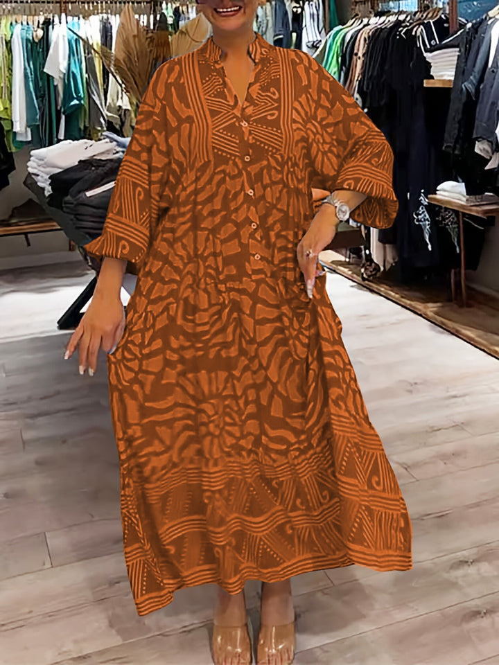 Woman wearing the Oonagh™ vivid printed maxi dress with a button front, standing confidently outdoors.
