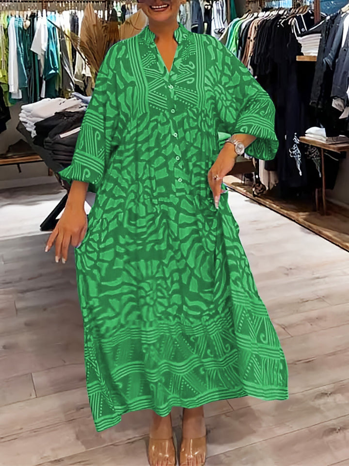 Woman wearing the Oonagh™ vivid printed maxi dress with a button front, standing confidently outdoors.