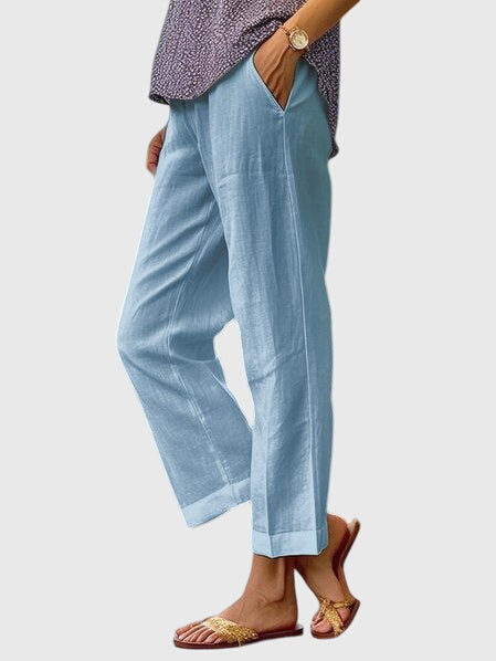 A woman wearing elegant tailored trousers with a flattering straight-leg cut and clean lines.