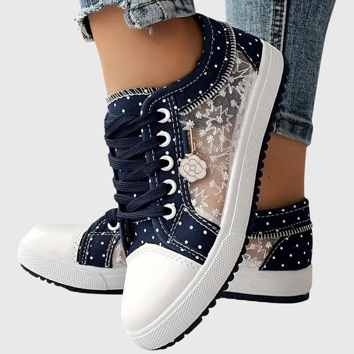 A woman walking comfortably in blue cushioned orthopaedic trainers