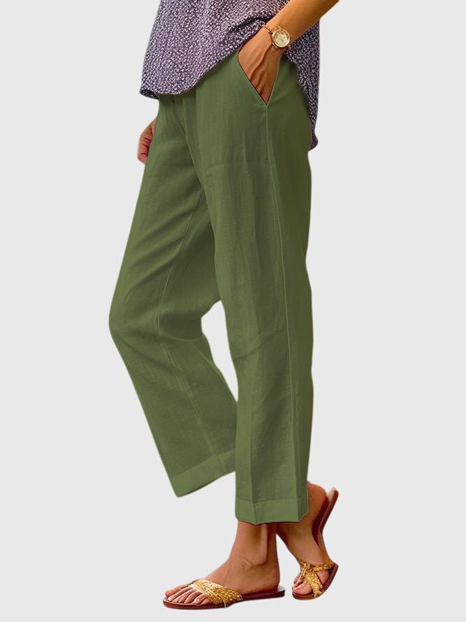 A woman wearing elegant tailored trousers with a flattering straight-leg cut and clean lines.