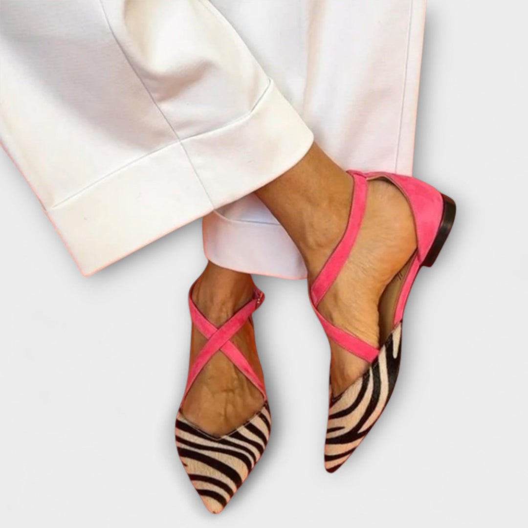 A woman wearing buckle-detail loafers on a refined day out.