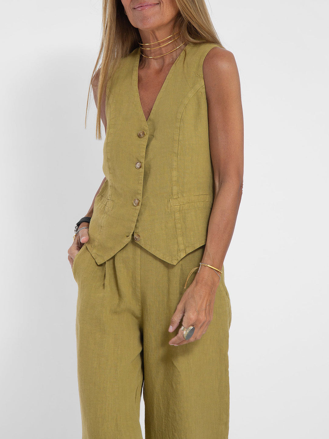A woman wearing a tailored waistcoat with flowing wide-leg trousers