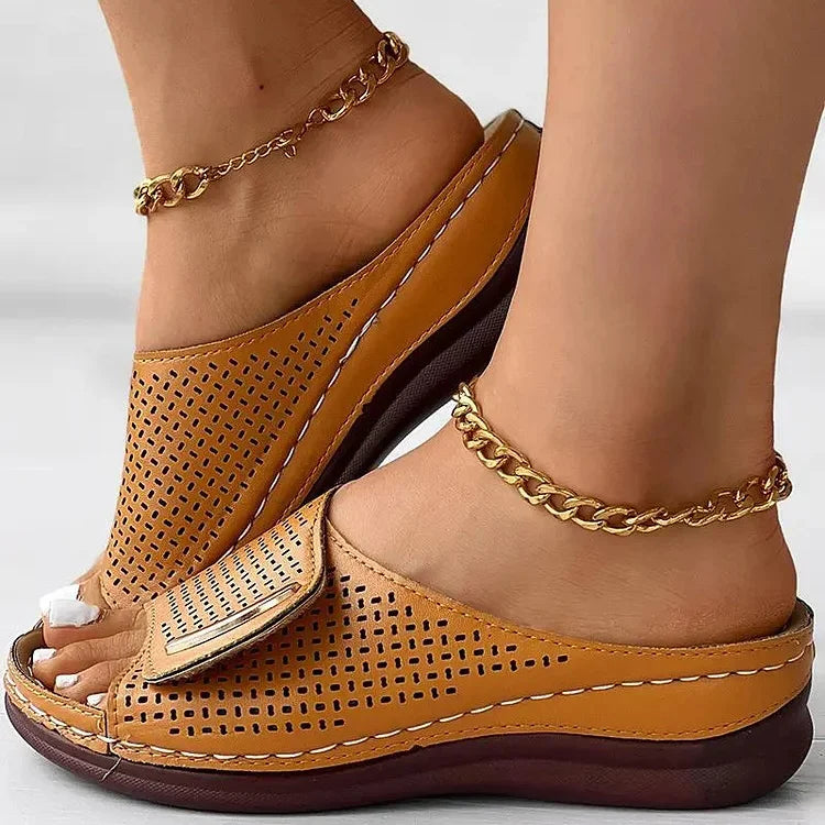 Open-work wedge sandals in bordeaux with a small metallic ornament on the upper