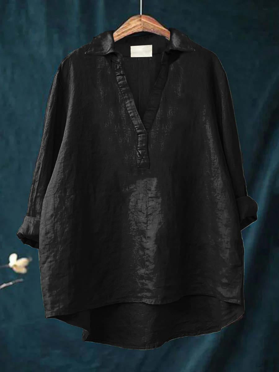 A woman wearing an elegant solid-colour summer blouse with an open V-neck, looking fresh and stylish on a warm day.