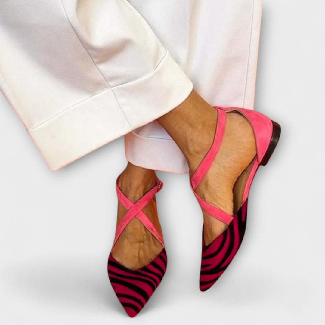 A woman wearing buckle-detail loafers on a refined day out.