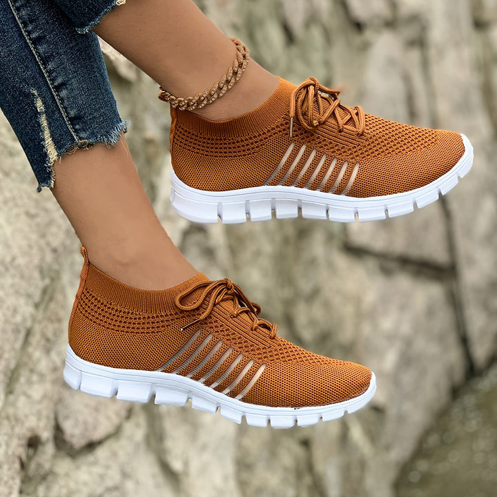 A woman wearing light breathable sock-style comfort shoes