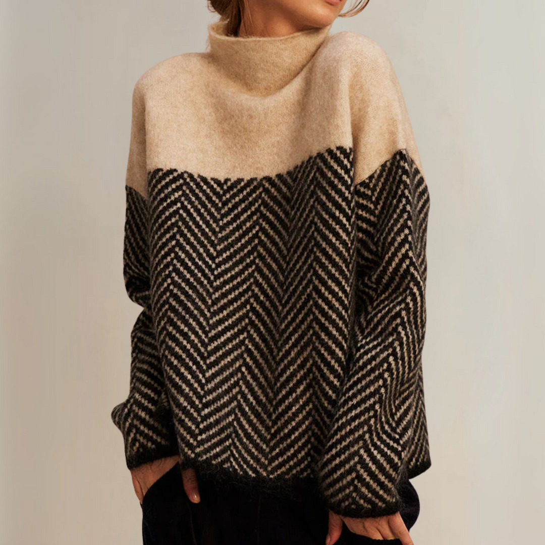 A woman wearing a zigzag-pattern funnel neck jumper styled elegantly for an autumn day out.