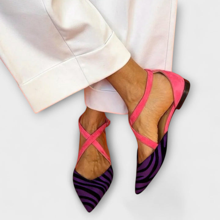 A woman wearing buckle-detail loafers on a refined day out.