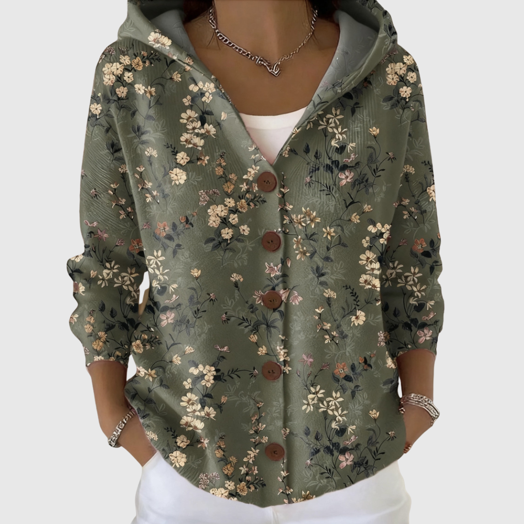 A woman wearing a cosy hooded cardigan worn alone over trousers on a mild morning.