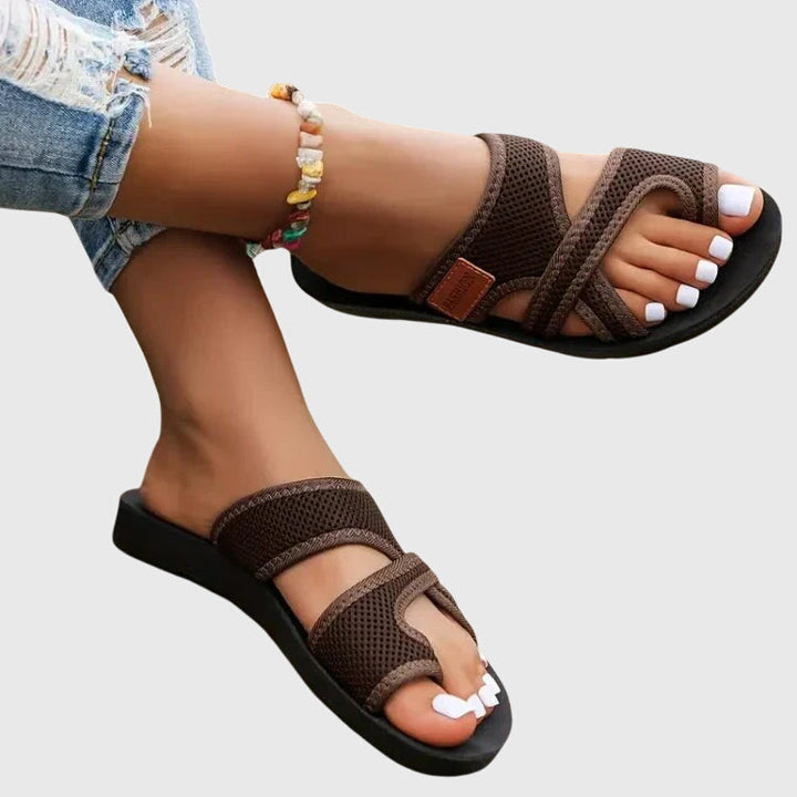 Lightweight flat sandal in black, also available in red and brown, with a simple clean design