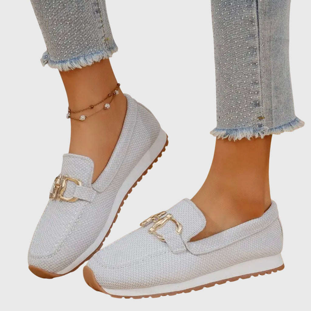 Women's beige comfort slip-on trainers with a cushioned sole and elegant metallic detail