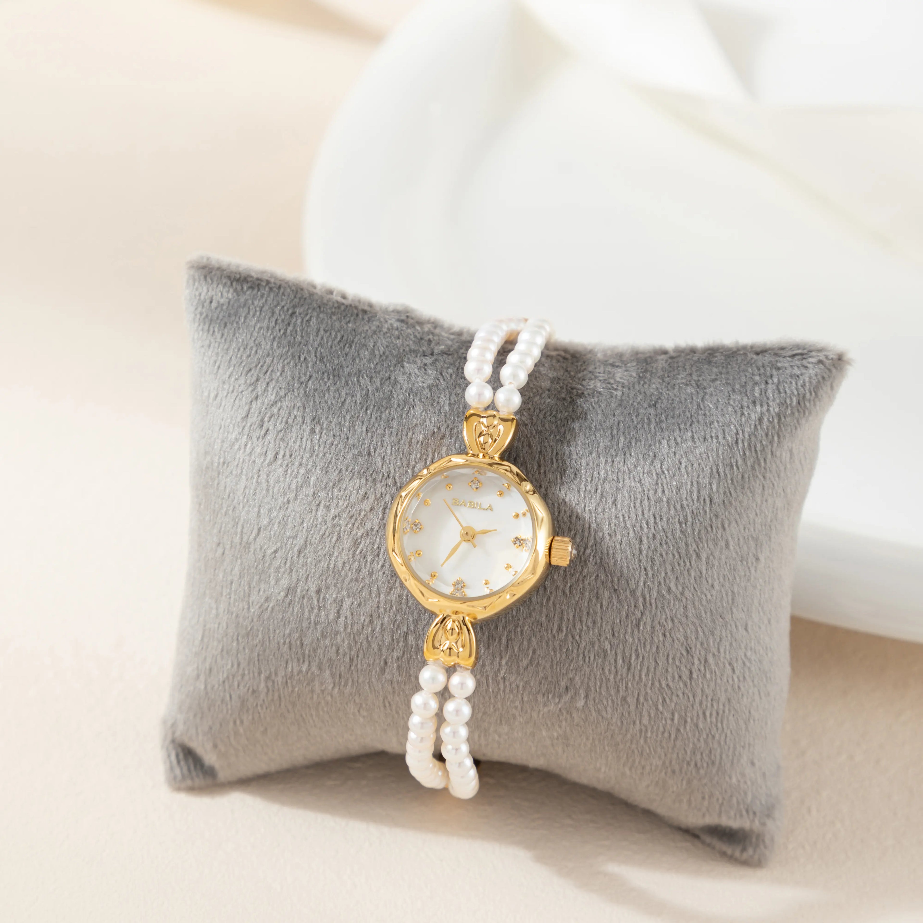 Women's gold watch with elegant twisted chain bracelet strap and a refined dial