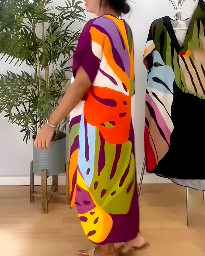 A woman wearing a colourful abstract print dress with a V-neckline and short sleeves.