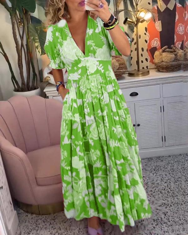 A woman wearing the Josephine bold floral maxi dress with a flowing full-length skirt at a garden gathering.