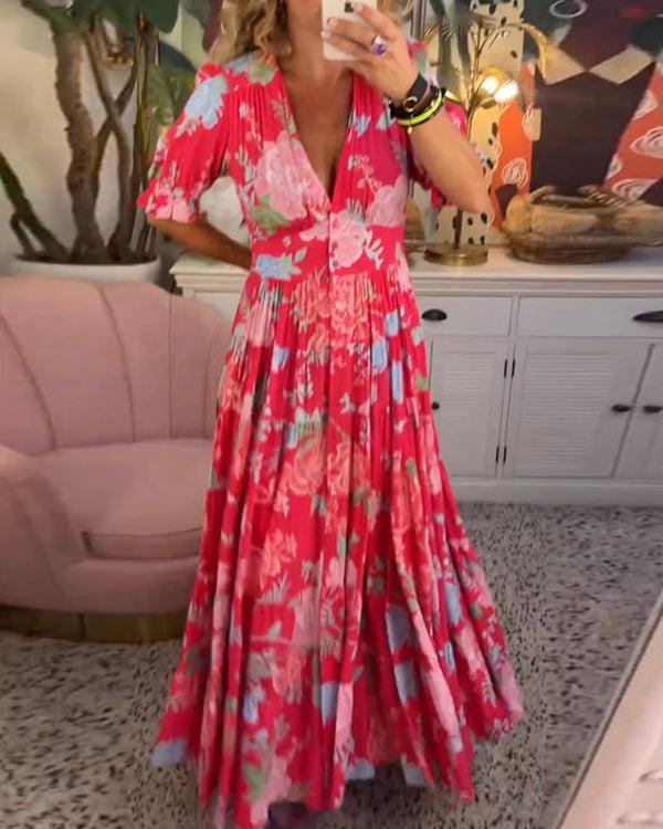 A woman wearing the Josephine bold floral maxi dress with a flowing full-length skirt at a garden gathering.
