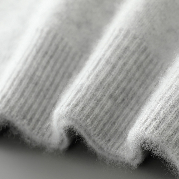 A woman wearing a soft luxe crew neck jumper with a matte finish, styled with smart trousers.