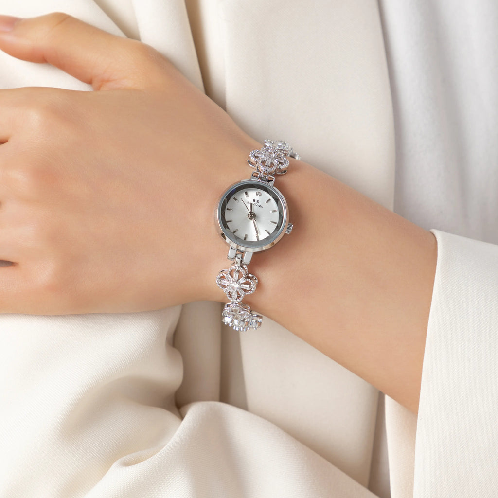 Women's gold-finish watch with rounded design and light-catching detailed face