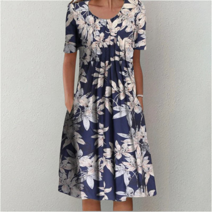 Woman wearing the floral midi dress with pockets, walking outdoors on a sunny day.