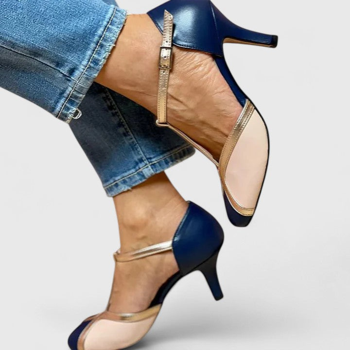 A woman wearing caramel T-strap heels, walking with grace and confidence.