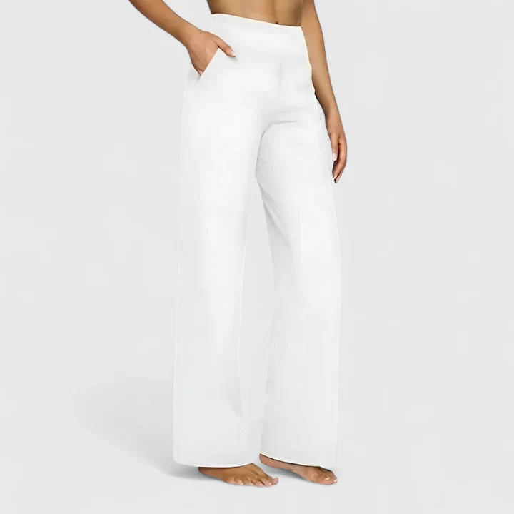 A woman in elegant straight-leg trousers with pockets, styled for a polished everyday look.