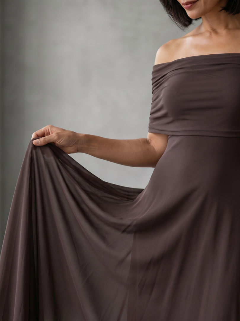 Brown midi dress with off-shoulder draped neckline and sheer outer layer over smooth lining