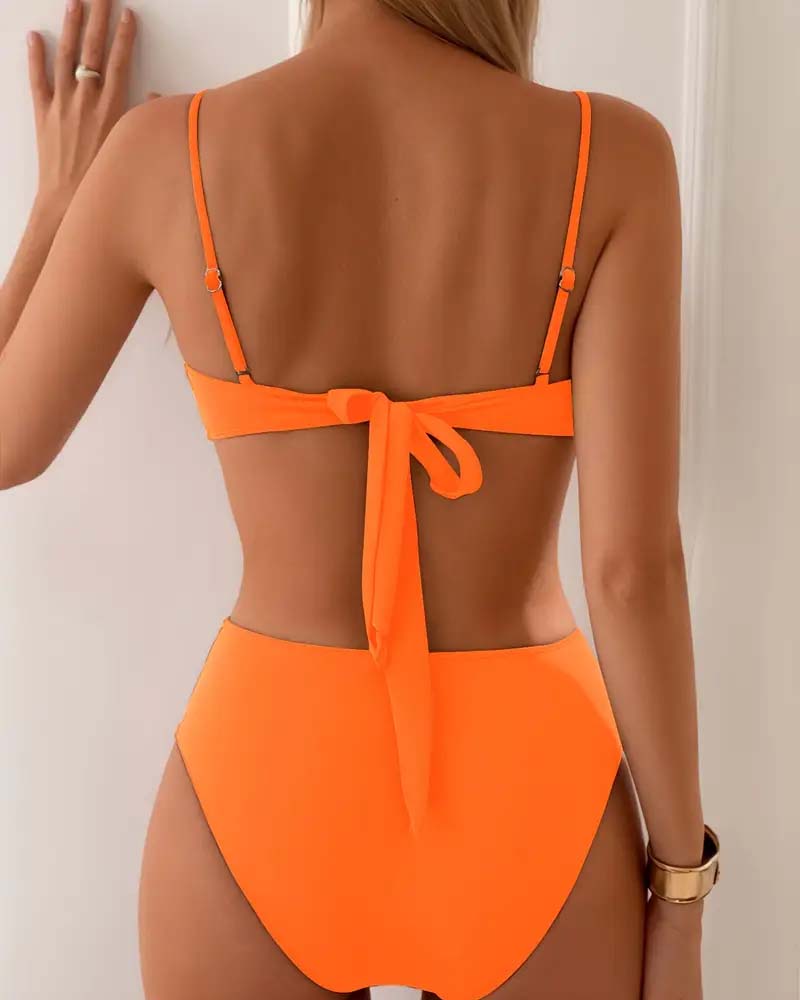 Navy blue bandeau bikini with a gold ring detail and colour-block panels