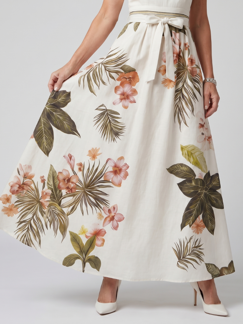 White botanical print halter maxi dress with a draped neckline and bow waist detail