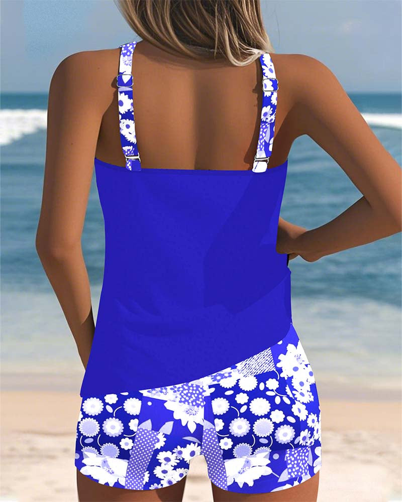 Floral tankini with shorts bottom in purple and soft tones, displayed on a light background