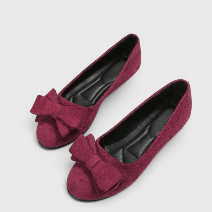 A woman walking easily in dark green classic comfort sandals with a broad, cushioned footbed.