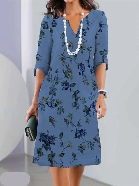 Woman wearing the Kathleen floral A-line dress in ivory, dressed for a daytime lunch.