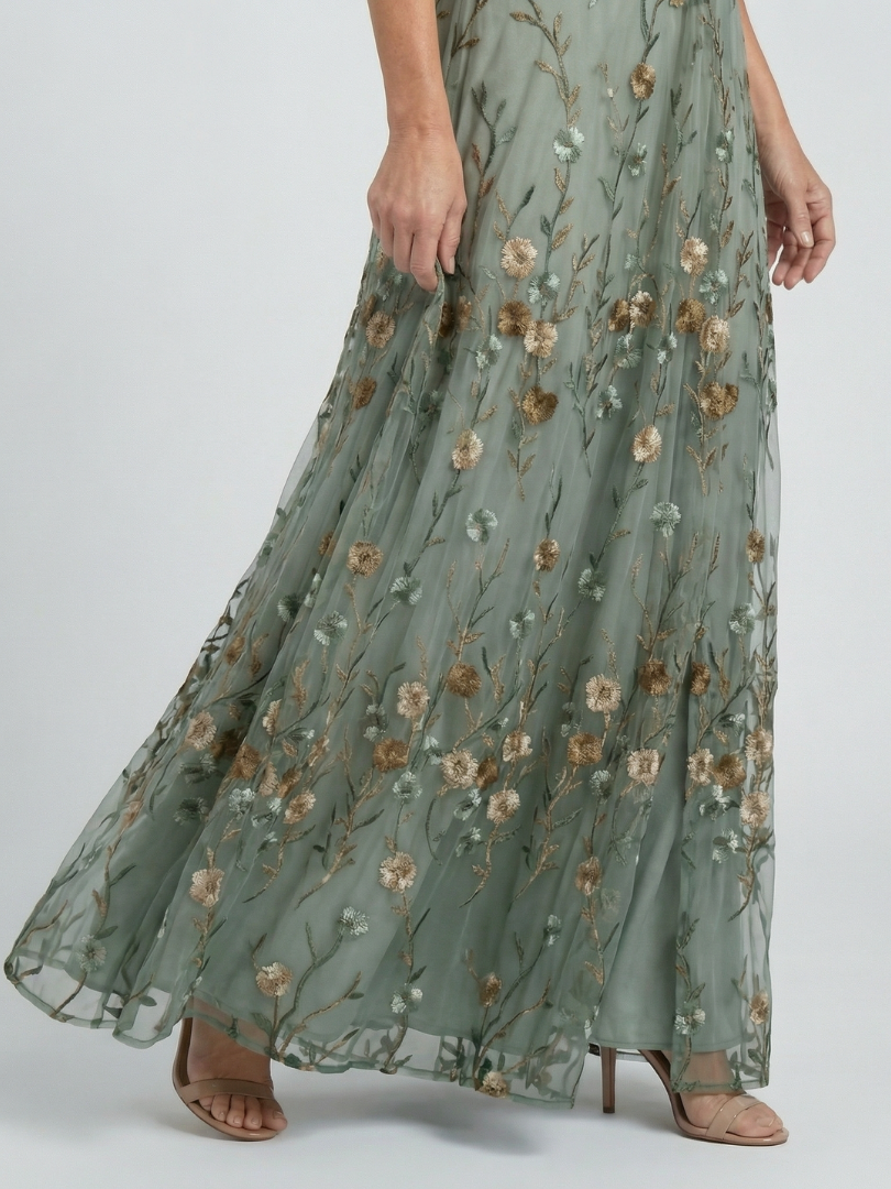 Sage green halter-neck midi dress with all-over floral print and loose flowing silhouette