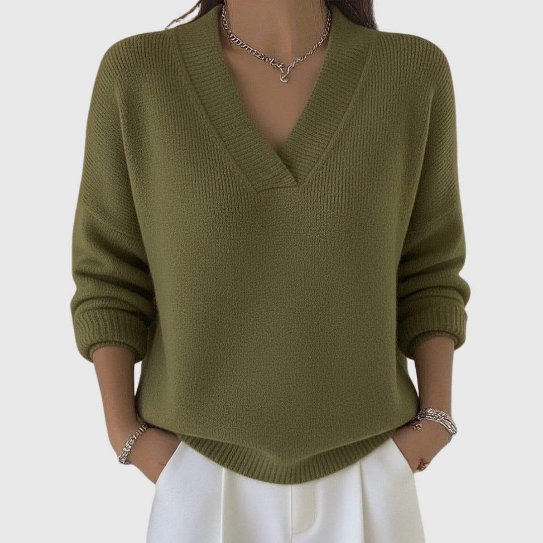A woman wearing a soft draped V-neck jumper with jeans for an effortlessly elegant look.