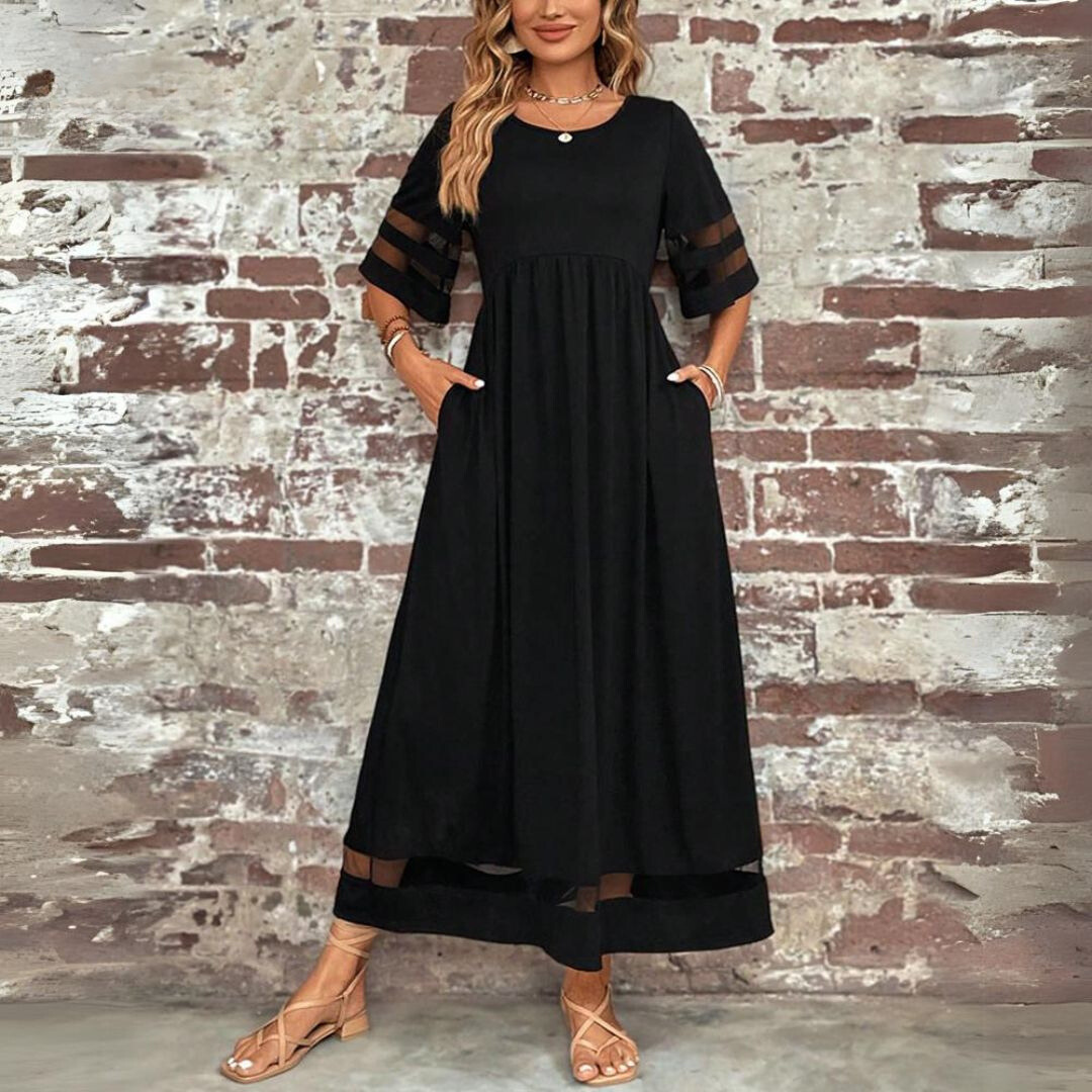 Woman wearing the Winifred™ empire waist midi dress with a flowing skirt and round neckline at a family gathering.