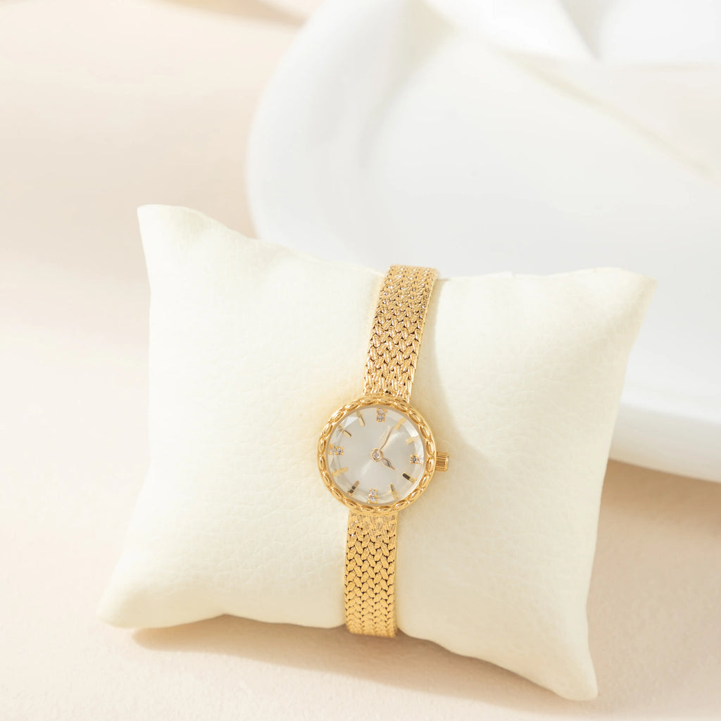 Women's minimalist gold watch with a simple round face and clean gold-tone finish