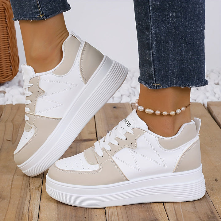 A woman wearing elegant two-tone platform trainers in the city