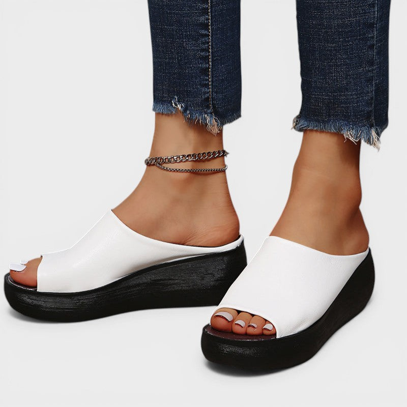 Open wedge mule sandals in white and brown with wide straps and a balanced wedge sole
