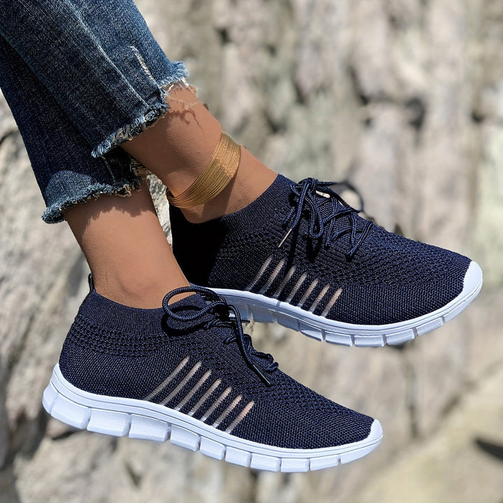 A woman wearing light breathable sock-style comfort shoes