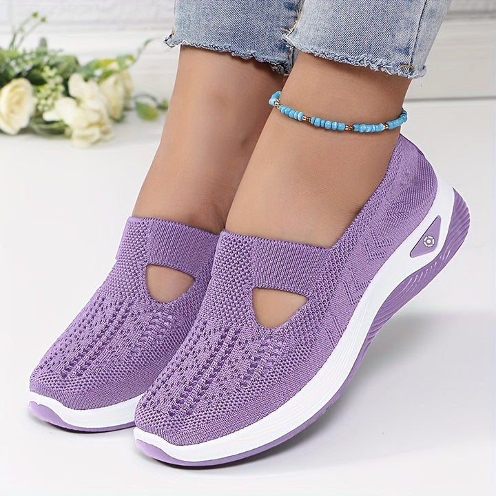 A woman stepping into easy slip-on comfort trainers with no laces.